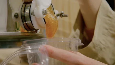 Female Hands Holding Plastic Container and Refilling Organic Honey. Concept of 스톡 동영상 144878991