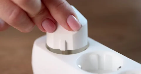 Female hands include an electric plug in a socket, close-up Stock Footage 233379792