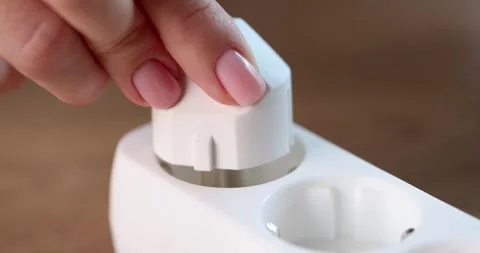 Female hands include an electric plug in a socket, close-up Stock Footage 255200045