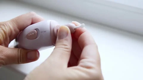 Female hands inserting a manicure drill bit into an electric nail drill machine. 스톡 동영상 339006247