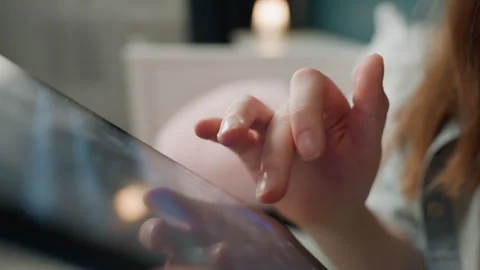 Female hands interact with device. Elegant woman exploring apps in cozy bedroom Stock Footage 333475860