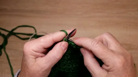 Female hands knits with green threads and needles on the table. View from above Stock Footage 224145751