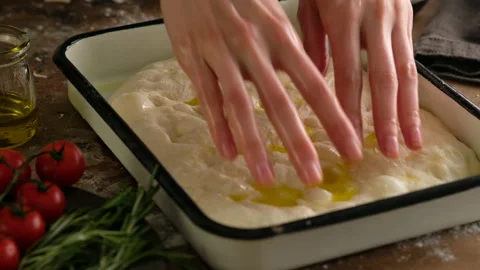 Female hands lay the dough in a baking tray, prepare Italian bread - focaccia Video stock 131801434