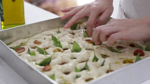 Female hands lay the dough in a baking tray, prepare Italian bread. Stock Footage