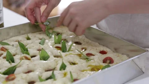 Female hands lay the dough in a baking tray, prepare Italian bread Stock Footage 138792257