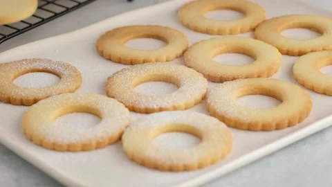 Female hands lay out hot cookies on a plate. Female hands a making homemade Stock Footage 146502671