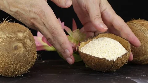Female hands lay the shell with grated coconut Stock Footage 122279650