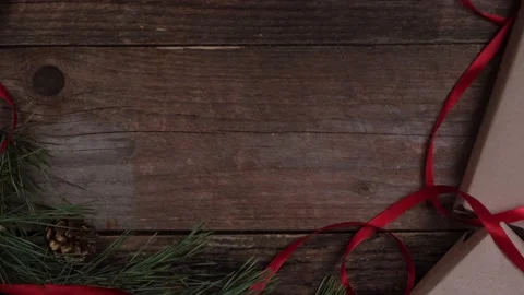 Female hands laying gift box with red ribbon. New year Christmas Stock Footage 167174980