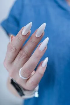 Female hands with long nails light white manicure 스톡 사진