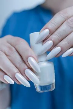 Female hands with long nails light white manicure 库存照片
