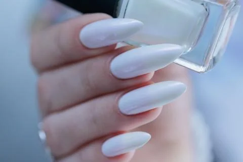 Female hands with long nails light white manicure Photos