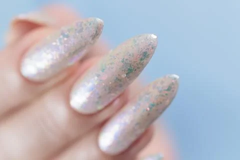Female hands with long nails light white manicure Stockfoto's