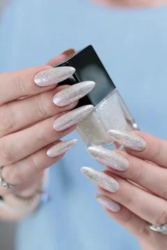 Female hands with long nails light white manicure Stock Photos