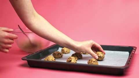 Female hands making Chocolate Chip Cookies raw dough bowls. Stock Footage 135701063