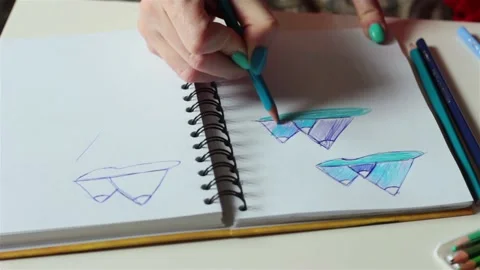 Female hands making drawing coloring sketch for stained window glass jewelry  Video stock 89647571