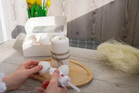 Female hands making egg shell handmade decoration for Easter holiday. Tutorial Stock Photos