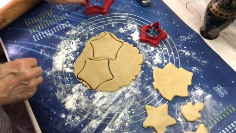 Female hands making ginger cookies using baking tin in shape of star. Stock Footage 122580807