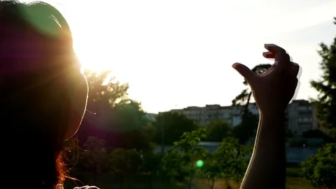 Female hands making heart shape gesture holding sun flare with fingers Stock Footage 114295042