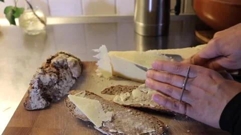 Female hands making rye bread double sandwich with swedish cheese slicer Stock Footage 170389255