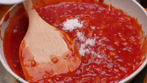 Female hands making tomato sauce for homemade pizza in a saucepan in kitchen. Stock-Footage 158669375