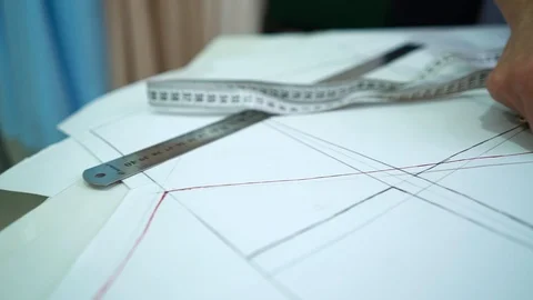 Female hands measuring sewing patterns in fashion atelier Stock Footage 122199513