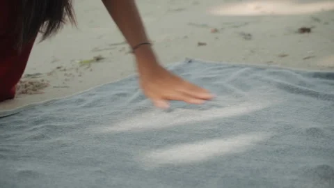 Female hands meticulously smoothing patterned towel. Focused scene of hands 스톡 동영상 335635690