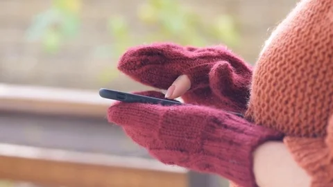 Female hands in mittens using smart phone. Stock Footage 82292035