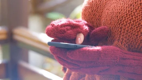 Female hands in mittens using smart phone. Stock Footage 82292104