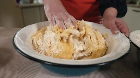 Female hands mixing soft dough in the kitchen, close-up. cooking paska, desserts Stock Footage 253486682