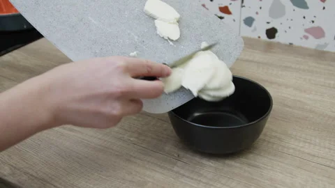 Female hands moving mozzarella slices into a bowl. Stock Footage 266419009