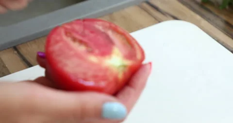 Female hands with multi-colored manicure cut and peel a tomatoes Stock Footage 133826896