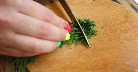 Female hands with multi-colored manicure cut dill for salad 스톡 동영상 133828243