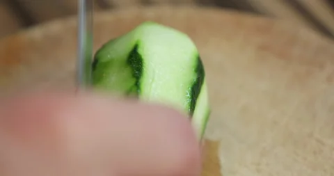 Female hands with multi-colored manicure cut cucumbers for salad Stock Footage 133831914