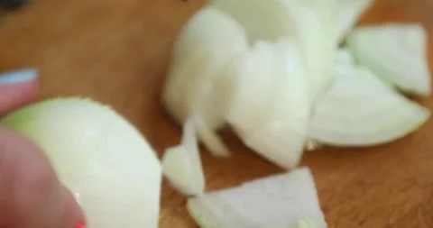 Female hands with multi-colored nails chop the onion into pieces Stock Footage 133829544