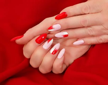 Female hands with a multicolored manicure closeup Stock Photos