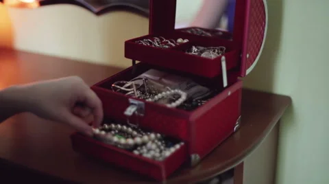 Female hands is opening red box for jewelry, and taken out of the box pearl bead Stock Footage 63237105