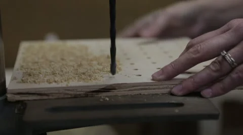 Female hands operating a drill press, saw dust blown off at end of clip Video stock 66932161