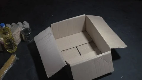Female hands packing a box of different products Stock Footage 118349536