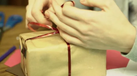 Female hands packing present and making it look perfect 스톡 동영상 59987508