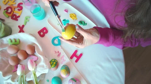 Female hands painting Easter eggs. Mother preparing for Easter. Top view. Easter Stock-Footage 151354271