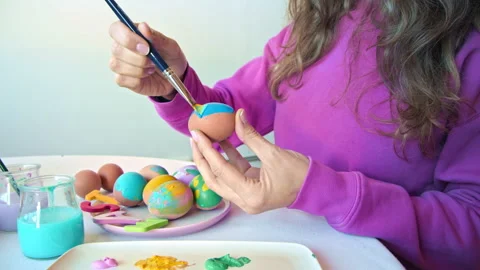 Female hands painting Easter eggs. Mother preparing for Easter. Top view. Easter Stock-Footage 151354697