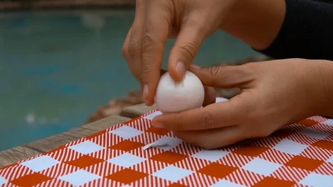 Female hands peel off an eggs shell on table 動画素材 120249703