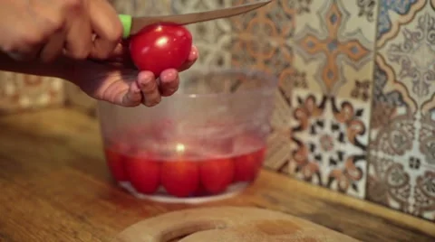 Female hands peeling boiled tomatoes in kitchen Video stock 65732018