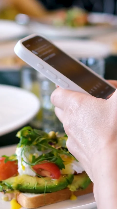 Female hands with a phone during breakfast at the buffet dinner table choose a Stock Footage 278578053