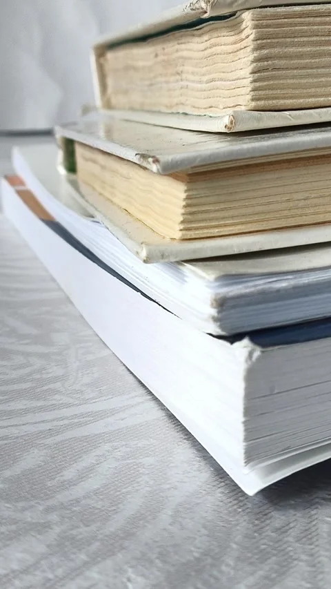 Female hands place a stack of books on the table Video stock 313978159