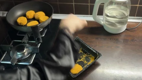 Female hands placing cutlets on oiled pan in kitchen Stock Footage 310503403
