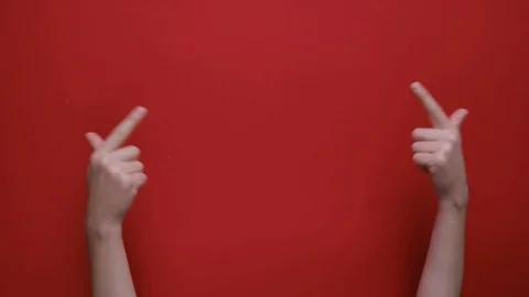 Female hands pointing on copy space and showing thumbs up over red background. Stock Footage 119779436