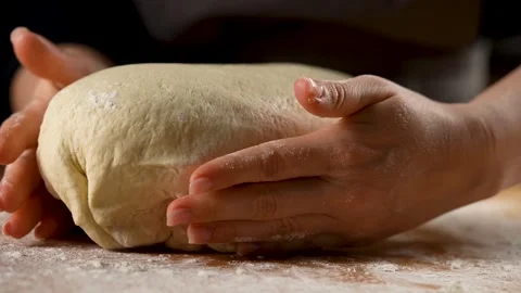Female hands preparing bread dough for putting in the oven in slow motion 4K Stock Footage 266224569