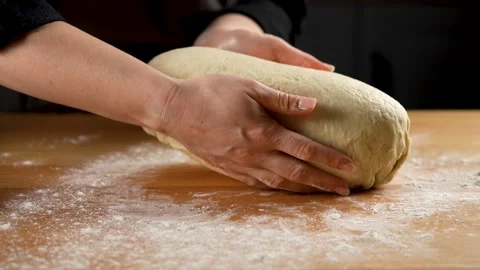 Female hands preparing bread dough for putting in the oven in slow motion 4K Stock Footage 266224713