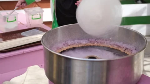 Female hands preparing cotton candy from sugar Stock Footage 257524807